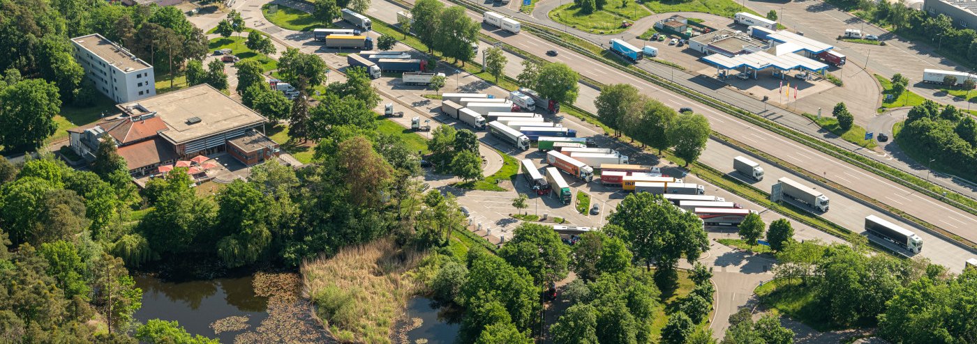 Aerial view of ah ighway with trucks and a service station - land-use in Germany